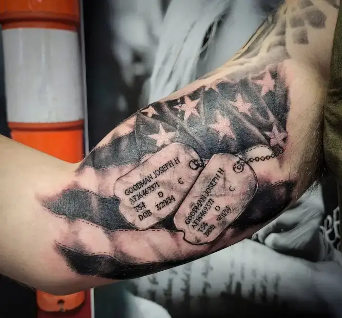 Color American flag torn skin tattoo on a forearm