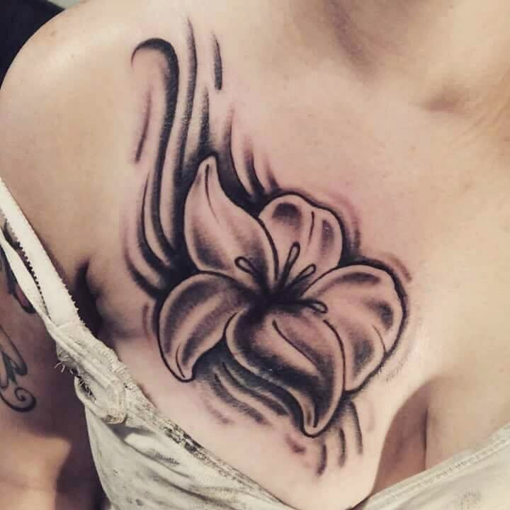 Black n white lily flower tattoo on chest