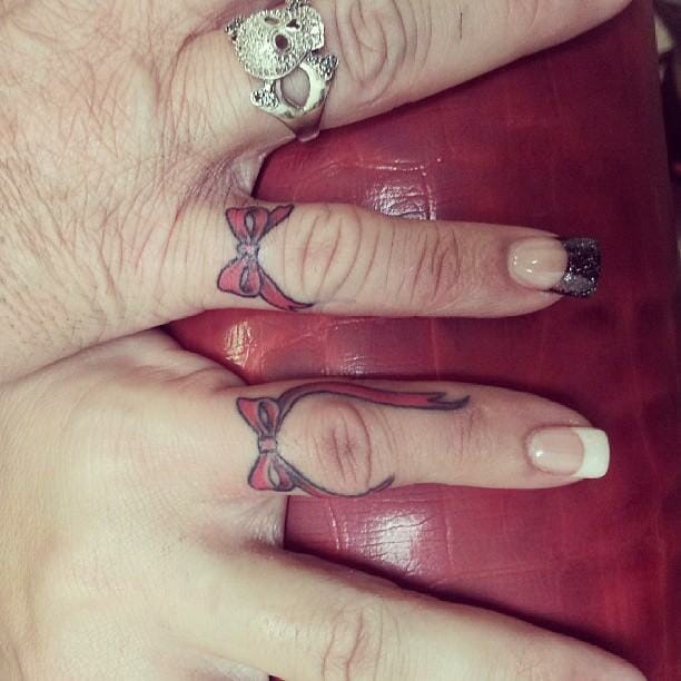 Bow tattoo on finger