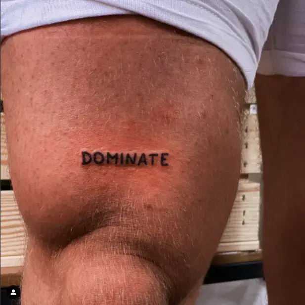 Dominate One Wording tattoo for thigh