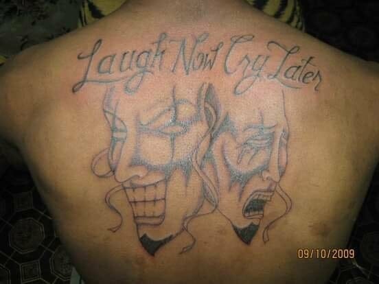 Laugh now cry later tattoo on back