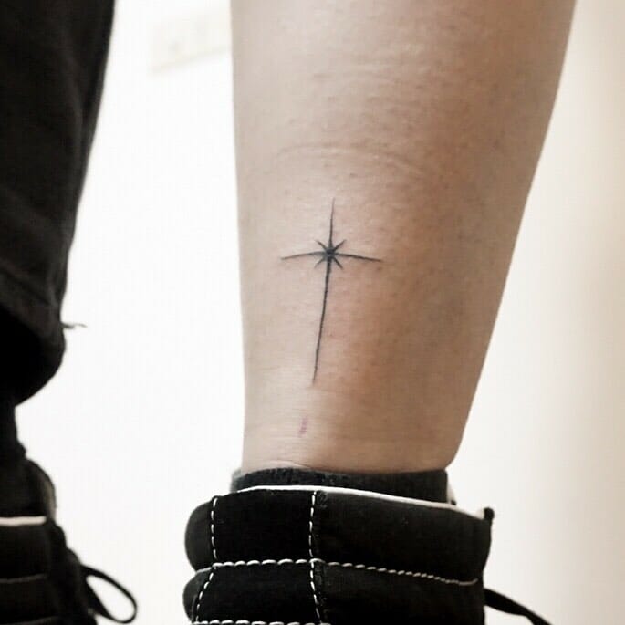Thin cross tattoo